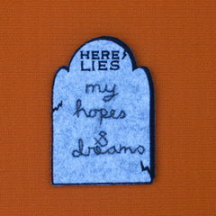 HERE LIES headstone patch with custom chain stitching.