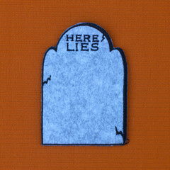 HERE LIES headstone patch with custom chain stitching.